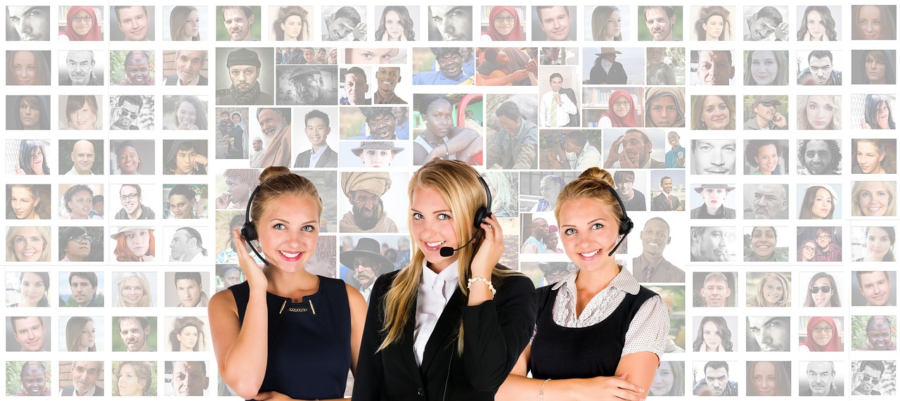 3 women with headsets in front of pics of people